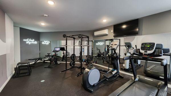 24/7 Fitness Center with Peloton & Squat Rack