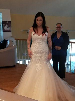 Sabrina helping the bride try on dresses