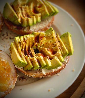 Homemade avocado, vegan cream cheese and Japanese BBQ sauce on an everything bagel.