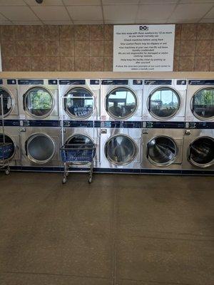 Dryers line the back and side walls of the large building,.