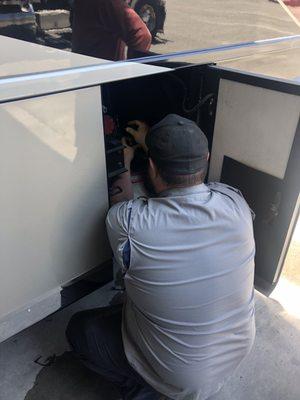 Mechanic, Scott, working in the small DEF compartment.