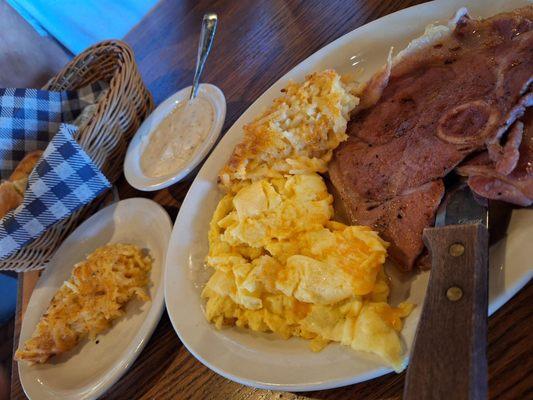 A Country Boy breakfast w/ Country Ham and scrambled eggs with Colby Jack cheese and two sides of hash brown casserole w biscuits and gravy.