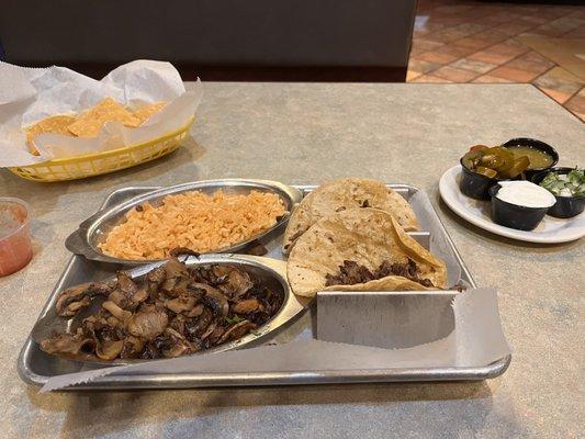 Tacos De Carne Asada, Mushrooms and Spanish Rice!  Side of cilantro with onions, jalapeños, sour cream & salsa verde!!