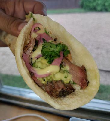 The Bark Taco on flour: smoked brisket, spicy guac, pickled onions, cilantro. Yum!