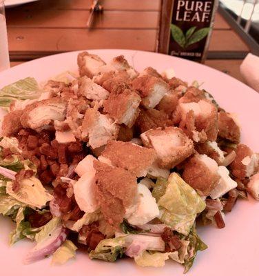 Junk salad (romaine, tomato, cucumber, red onion, bacon, feta, and fried chicken, tossed with Parmesan Peppercorn Ranch)