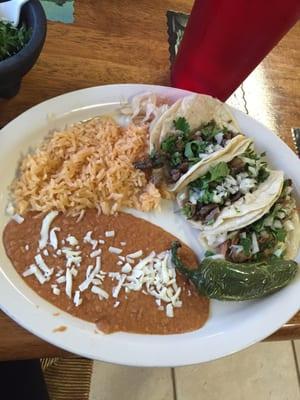 Asada & carnitas tacos with rice and beans. A little cold and not super flavorful.