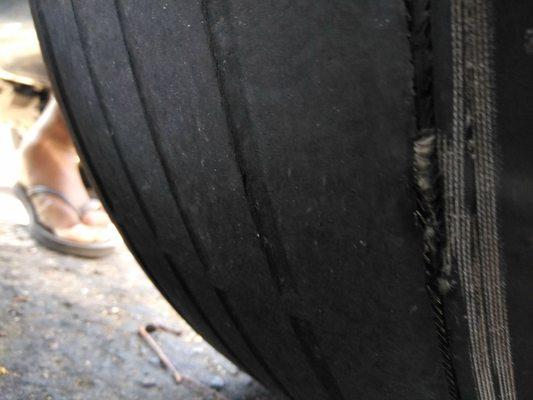 My tire after it was "changed". Technician suggested I was lying and said he in fact did change it... This shows the inside of the tire.