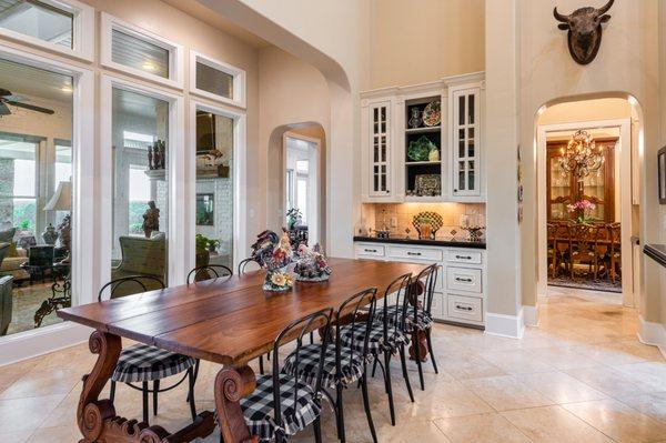 Dining room with built-ins and windows at East TX ranch for sale.