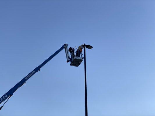 Installing a parking lot light at the Mocks Corner Walmart.