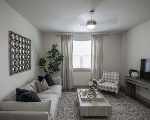 Open living area with ceiling fans