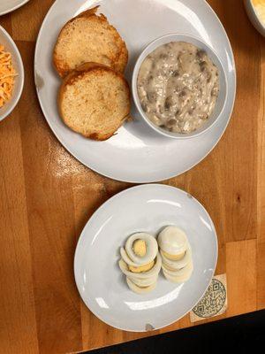 Biscuit and gravy with two boiled eggs