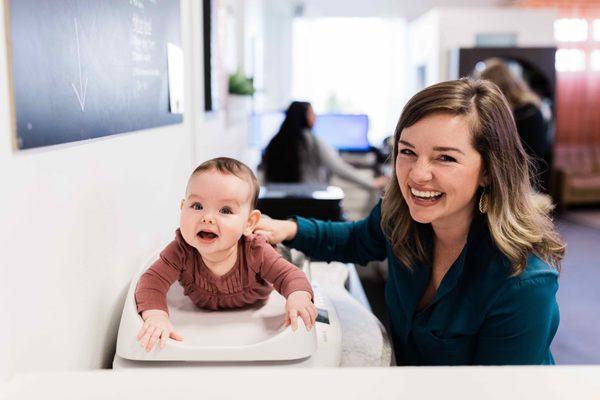 Emily weighing a baby at Fern and Foster