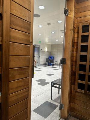 Large room where saunas & steam room are located. Between men's and women's fitting room.