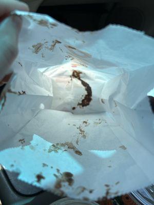 Mess from donut being places upside down in bag