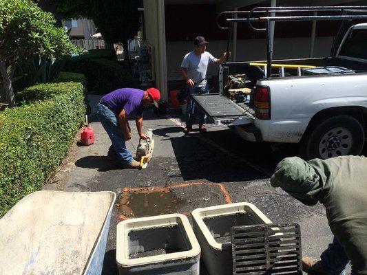 Commercial installation of a parking area drain and sump pit. Call now if you have any standing water issues in your parking area!