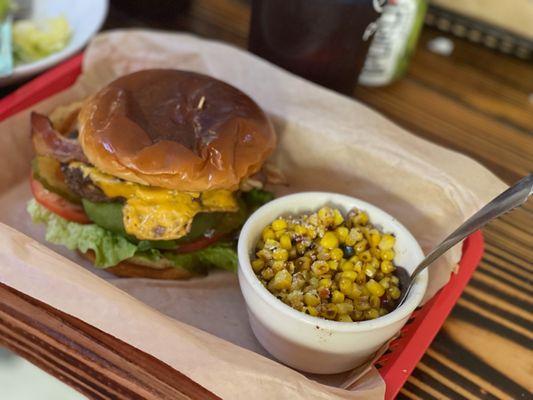 The classic burger (add bacon & avocado) with corn