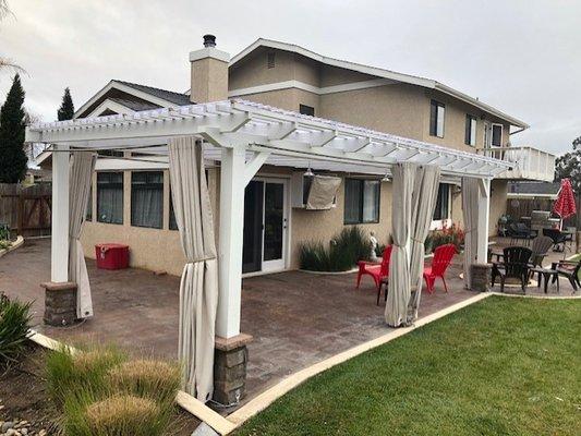 Custom built patio cover with sliding drapes for privacy