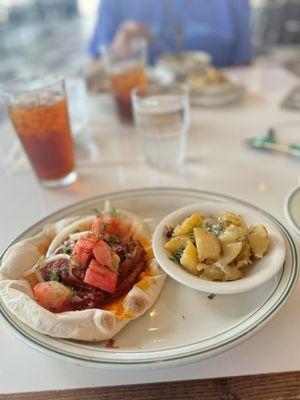 Braised lamb pita sandwich with lemon potatoes. Pita is super fresh and braised lamb with onions and tomatoes made for a great sandwich.