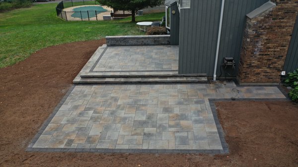 Two level paver patio with sitting wall.