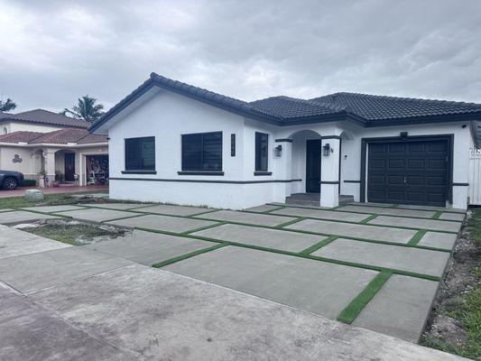 Asymmetrical squares with turf driveway.