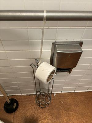 The original toilet paper fixture is not in use, the 2nd toilet paper holder is held up with plastic, which is not sanitary or aesthetic.