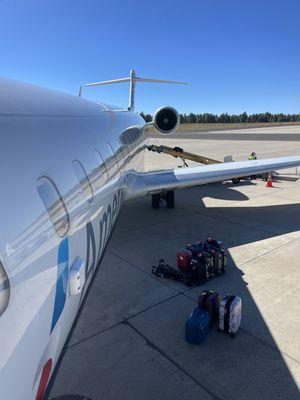 Boarding the plane -- the planes don't have much overhead bin space, so larger carryons will go under