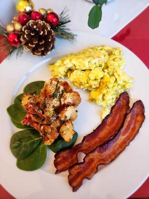 Breakfast, pesto eggs with tomato strata and bacon.