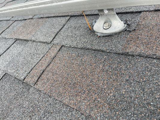 The piece of wood sticking through the roof is to Show one of the several holes drilled while trying to find the stud.