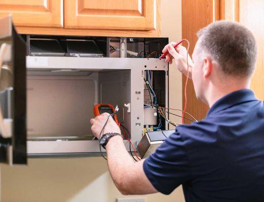 Our professional worker is reparing the microwave oven