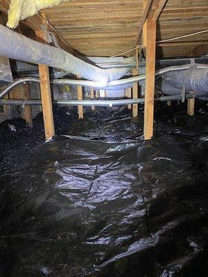 A new vapor barrier installed in a crawl space