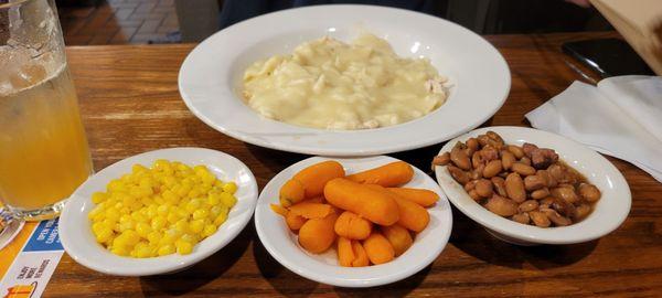 Chicken and dumplings, corn, carrots, and pinto beans