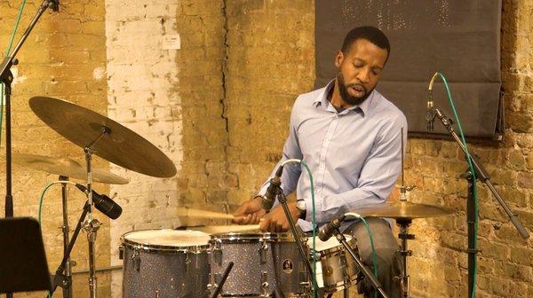 Screengrab of a friend playing the drums during a Jazz Show that I filmed.