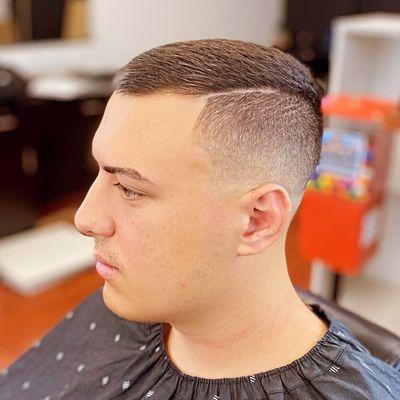 Mid skin fade with hard part