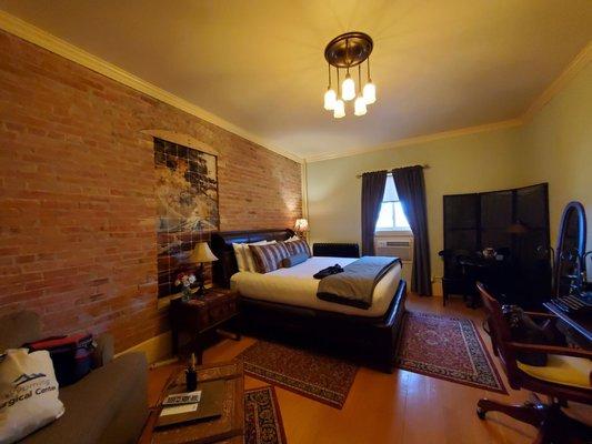 Nice bed with brick walls and a window that actually opens to the beautiful courtyard.