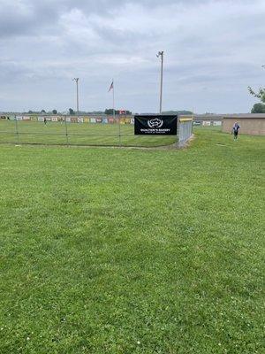 Local softball sponsor banner.