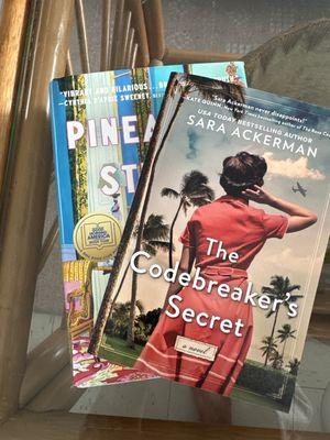 Two books, The Codebreaker's Secret by Sara Ackerman and Pineapple Street by Jenny Jackson.