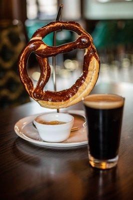 Large pretzel served with beer cheese, perfect snack while watching the World Cup