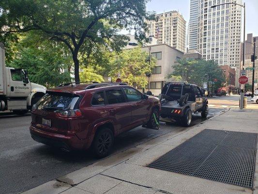 Vehicle being towed in downtown Chicago