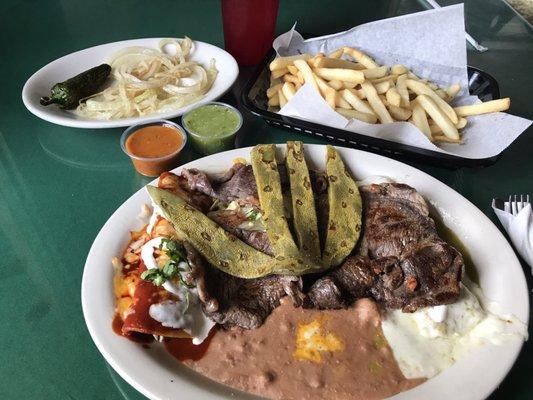 Outstanding beef steak with sautéed onions, two chicken enchiladas ( one red and one green sauce ) with white cheese, cactus!