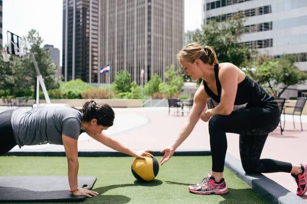 Coach Sady & Explorer Melissa - Personal Training on turf rooftop in Downtown Denver