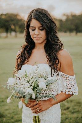 Bride looking down at flowers