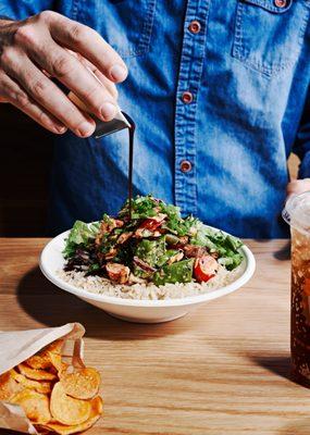 Our sweet soy sriracha bowl is packed with snow peas, red bell pepper, cabbage + carrot salad tossed in sriracha ginger dressing.