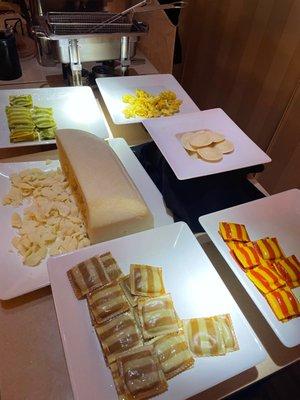 Pasta cocktail hour stations: assorted raviolis, parm, eggplant rollatini, and mini calzones