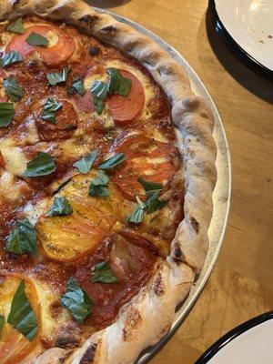 Farm to table seasonal pizza with heirloom tomatoes.