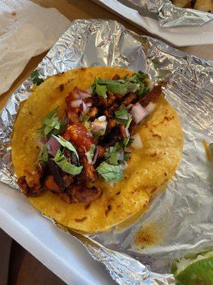 Al pastor on corn tortilla