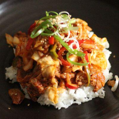 Spicy Pork Bulgogi Bowl - Gochujang-based marinated pork stir-fried with vegetables and served on white rice.