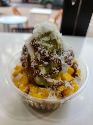 Avocado bowl with mango, coconut and almond butter