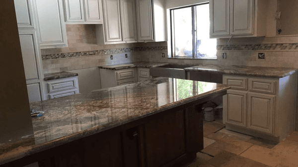 Granite counters with 6 x 6 Travertine back splash and 4" glass accent with 2 rows of pencil liner top and bottom of accent.