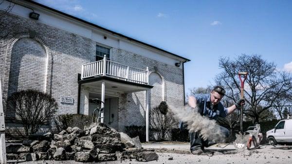 Matt of The Scottish Plumber performing a sewer repair in the parking lot of a school in Barrington.