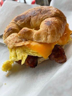 Breakfast Sandwich: croissant w/ egg&cheese&bacon. $ 6